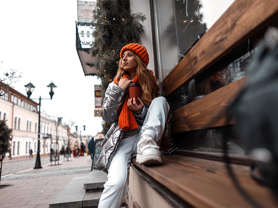 woman wearing white sneakers during winter Fashion.ie